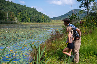 A girl and her father admiring some wetlands. Link to Life Stage Gift Planner Under Age 45 Situations.
