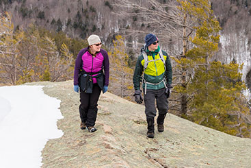 Two people hiking through a forest. Link to Life Stage Gift Planner Ages 45-65 Situations.